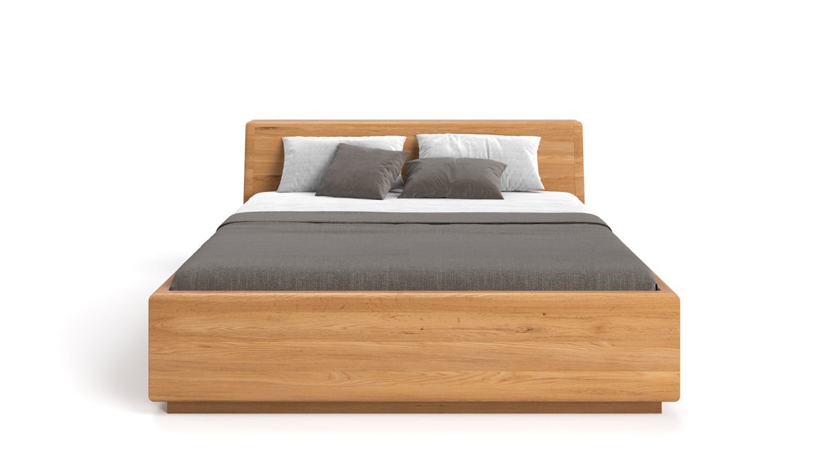 Designers houten bed Calveno van massief eiken met opbergruimte en schuin hoofdeinde